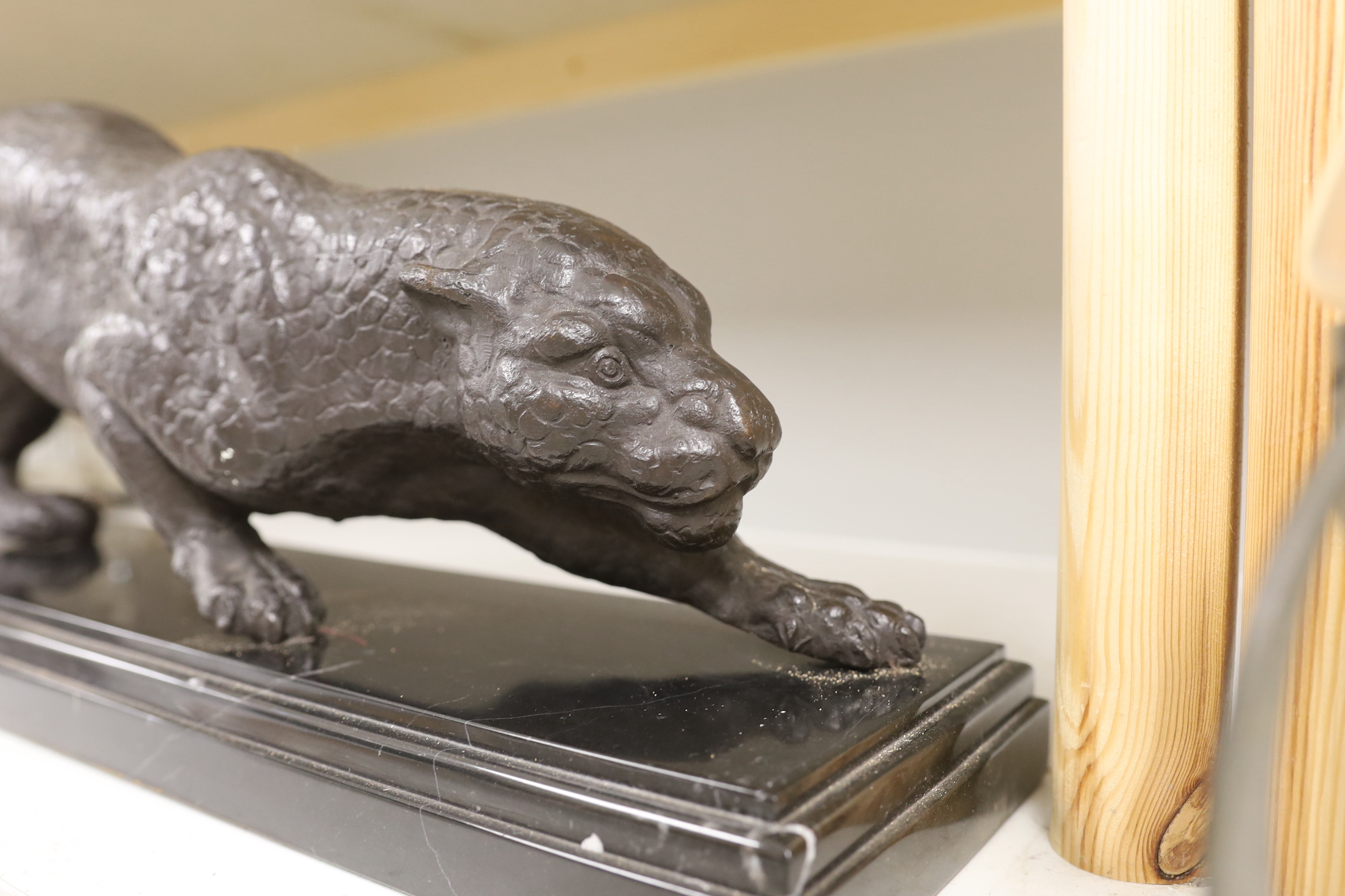 A bronze figure of a leopard, on black marble base, 67cm wide, 22cm high